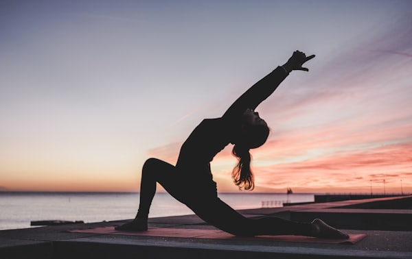 Person performing a yoga pose on mat